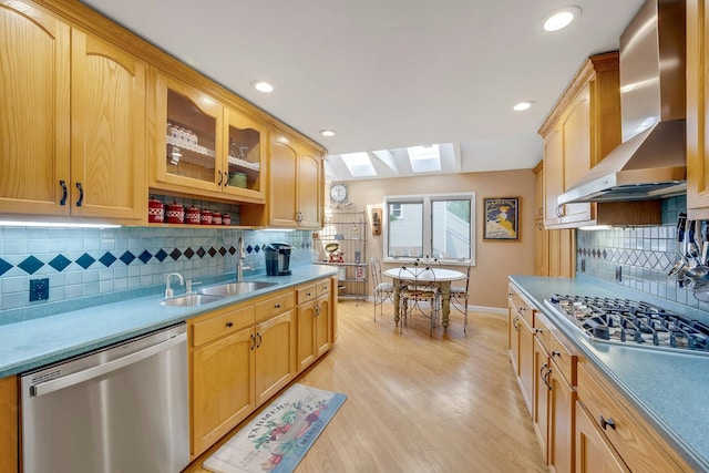 76 Boulder Ridge Rd, Scarsdale, NY 10583 - kitchen featuring appliances with stainless steel finishes, wall chimney range hood, a skylight, backsplash, and glass insert cabinets
