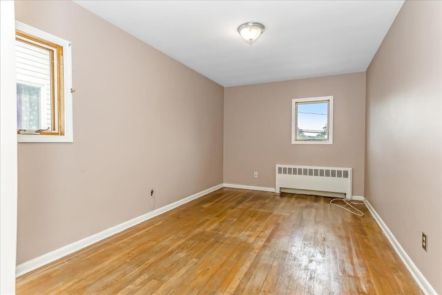 165 Wheeler Ave, Valley Stream, NY 11580 - spare room with radiator and light wood-type flooring