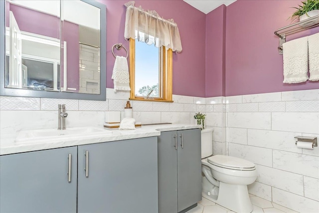 165 Wheeler Ave, Valley Stream, NY 11580 - bathroom featuring vanity, tile patterned floors, and tile walls