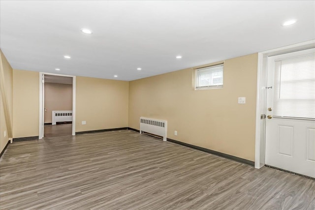 165 Wheeler Ave, Valley Stream, NY 11580 - below grade area with radiator heating unit, light wood-type flooring, and recessed lighting