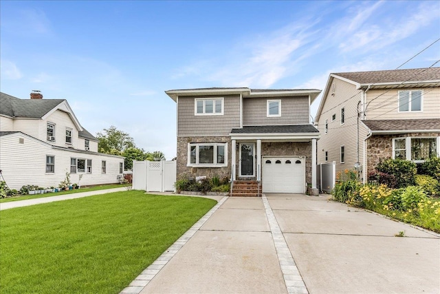165 Wheeler Ave, Valley Stream, NY 11580 - view of front of property featuring an attached garage, concrete driveway, stone siding, and a gate