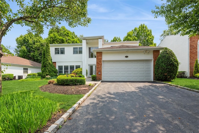 166 Country Club Dr Unit 166, Commack, NY 11725 - view of front facade with asphalt driveway, a garage, and brick siding