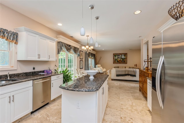 166 Country Club Dr Unit 166, Commack, NY 11725 - kitchen with appliances with stainless steel finishes, open floor plan, white cabinetry, a kitchen island, and a chandelier