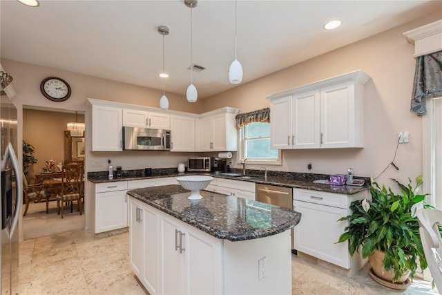 166 Country Club Dr Unit 166, Commack, NY 11725 - kitchen with appliances with stainless steel finishes, white cabinetry, a center island, recessed lighting, and hanging light fixtures