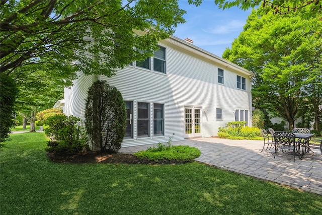 166 Country Club Dr Unit 166, Commack, NY 11725 - rear view of house featuring a patio, a lawn, and french doors