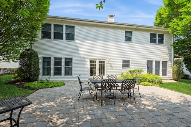 166 Country Club Dr Unit 166, Commack, NY 11725 - rear view of house featuring a patio, a chimney, and outdoor dining space