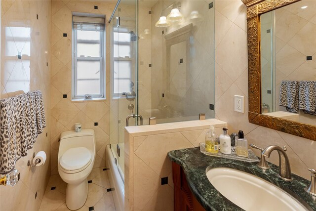 3001 Henry Hudson Pkwy Unit 1Fg, Bronx, NY 10463 - bathroom with tile walls, vanity, shower / bath combination with glass door, and tile patterned floors