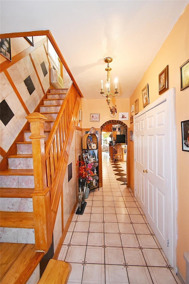 517 Westchester Ave, Mount Vernon, NY 10552 - foyer entrance featuring arched walkways, stairs, a chandelier, and light tile patterned flooring