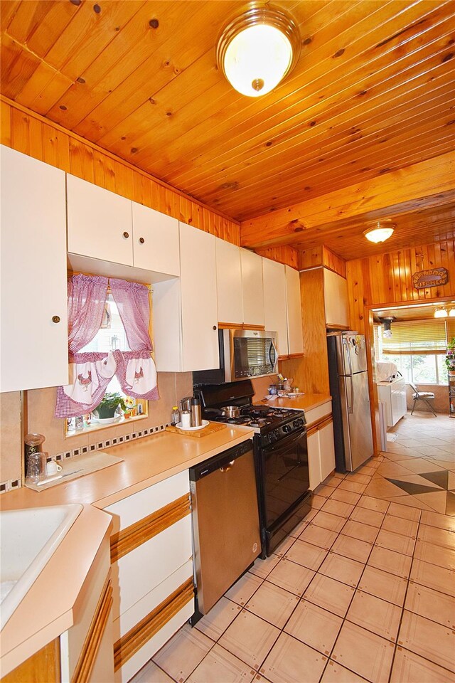 517 Westchester Ave, Mount Vernon, NY 10552 - kitchen featuring appliances with stainless steel finishes, wood ceiling, independent washer and dryer, white cabinets, and light countertops