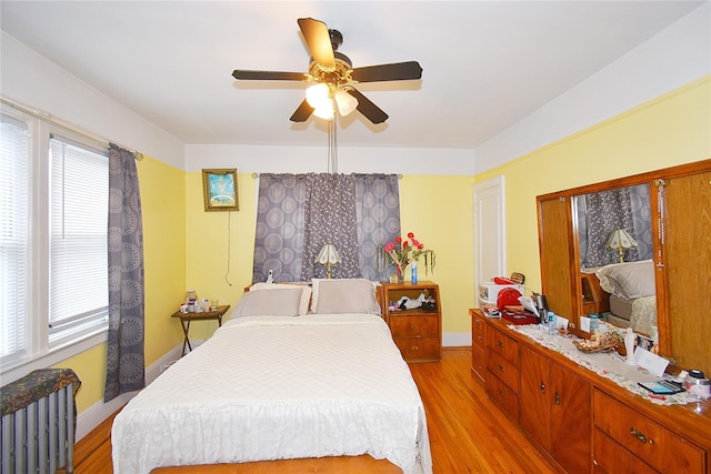 517 Westchester Ave, Mount Vernon, NY 10552 - bedroom with light wood-style flooring, a ceiling fan, and radiator