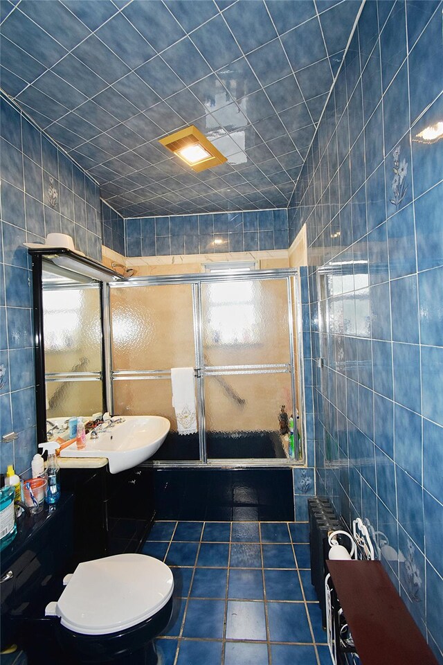 517 Westchester Ave, Mount Vernon, NY 10552 - bathroom with tile walls, a stall shower, tile patterned floors, radiator heating unit, and vanity