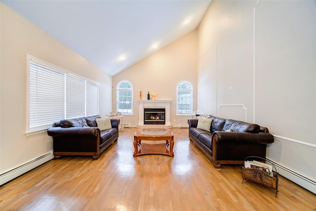 83 N Airmont Rd, Suffern, NY 10901 - living room with baseboard heating, high vaulted ceiling, light wood finished floors, and a fireplace
