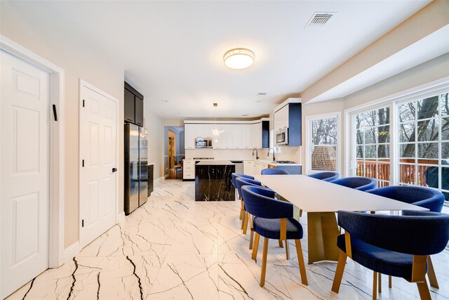 83 N Airmont Rd, Suffern, NY 10901 - dining area featuring light marble finish floors and baseboards