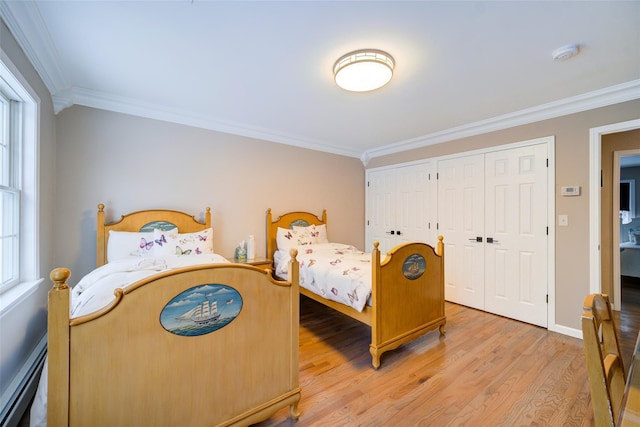83 N Airmont Rd, Suffern, NY 10901 - bedroom featuring crown molding, light wood-type flooring, a baseboard heating unit, multiple closets, and multiple windows