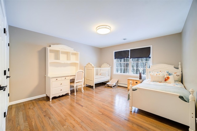 83 N Airmont Rd, Suffern, NY 10901 - bedroom with a baseboard heating unit and light wood finished floors