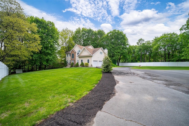83 N Airmont Rd, Suffern, NY 10901 - view of front of property featuring a garage, driveway, and view of wooded area