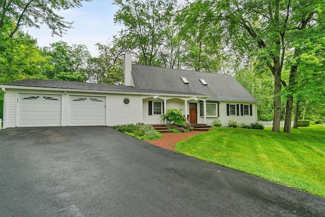 9 Schnabl Ct, Wappingers Falls, NY 12590 - view of front facade with asphalt driveway, a garage, a front lawn, a chimney, and covered porch