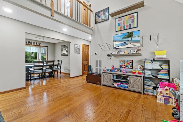 9 Schnabl Ct, Wappingers Falls, NY 12590 - living room featuring light wood-style flooring, a high ceiling, and recessed lighting