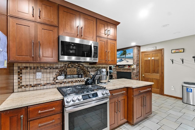 9 Schnabl Ct, Wappingers Falls, NY 12590 - kitchen with appliances with stainless steel finishes, tasteful backsplash, light stone countertops, and brown cabinets