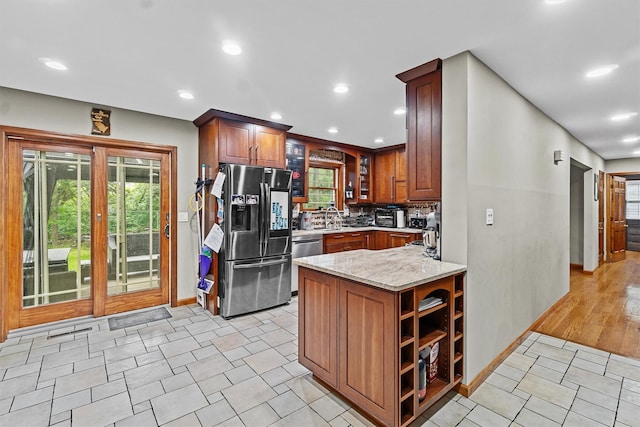 9 Schnabl Ct, Wappingers Falls, NY 12590 - kitchen with stainless steel appliances, light stone counters, tasteful backsplash, brown cabinets, and recessed lighting