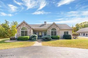 138 Lydon Ln, Hannacroix, NY 12124 - view of front facade featuring stone siding and a front lawn