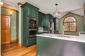 138 Lydon Ln, Hannacroix, NY 12124 - kitchen with green cabinets, stainless steel appliances, light wood-type flooring, a chandelier, and decorative light fixtures