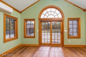 138 Lydon Ln, Hannacroix, NY 12124 - entryway featuring crown molding, a wall mounted AC, lofted ceiling, wood finished floors, and french doors