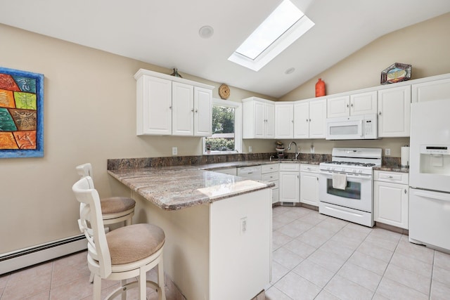 41 Whitman St, Congers, NY 10920 - kitchen featuring white appliances, a peninsula, a skylight, vaulted ceiling, and white cabinetry