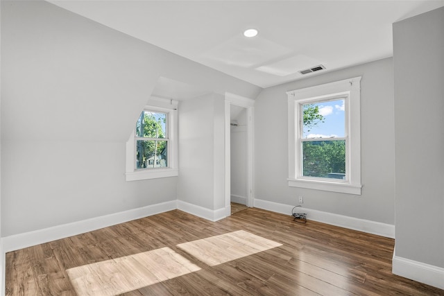 5 Putnam Ter, Brewster, NY 10509 - unfurnished bedroom featuring multiple windows, wood finished floors, vaulted ceiling, and a closet