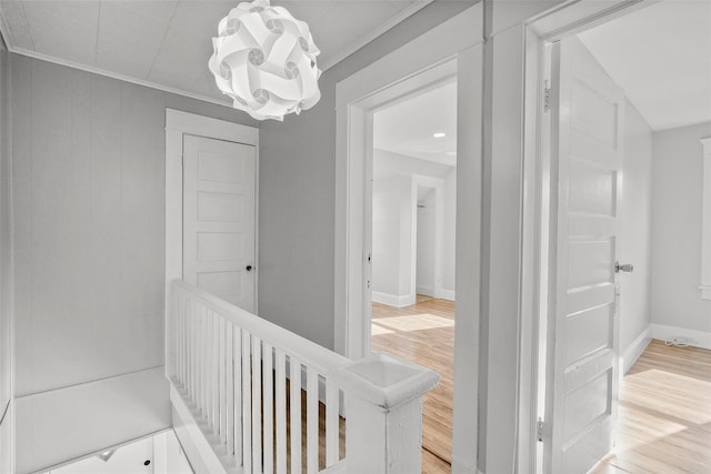 5 Putnam Ter, Brewster, NY 10509 - corridor featuring light wood finished floors, ornamental molding, a chandelier, and an upstairs landing