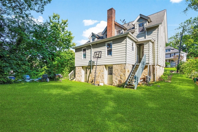 5 Putnam Ter, Brewster, NY 10509 - back of house with stairs, a yard, and a chimney