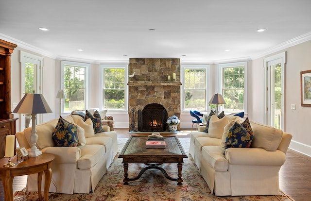 1 Simon Ct, Quogue, NY 11959 - living area with ornamental molding, wood finished floors, a stone fireplace, and recessed lighting