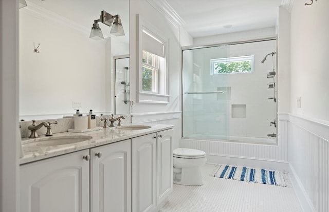 1 Simon Ct, Quogue, NY 11959 - full bathroom featuring shower / bath combination with glass door, double vanity, wainscoting, tile patterned floors, and crown molding