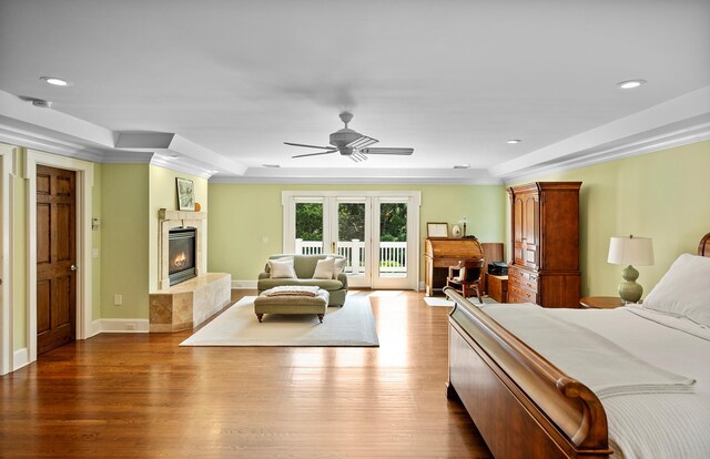 1 Simon Ct, Quogue, NY 11959 - bedroom featuring access to exterior, a tile fireplace, dark wood-style floors, recessed lighting, and a ceiling fan