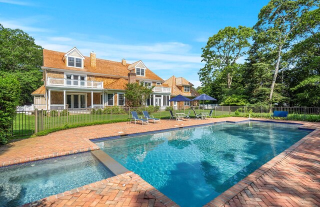 1 Simon Ct, Quogue, NY 11959 - view of swimming pool featuring a patio area, a fenced backyard, a pool with connected hot tub, and french doors
