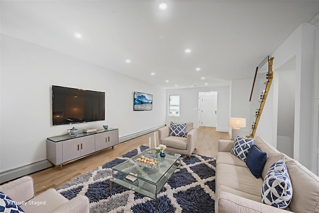 13015 Sutter Ave, South Ozone Park, NY 11420 - living area featuring wood finished floors, recessed lighting, a baseboard heating unit, and baseboard heating