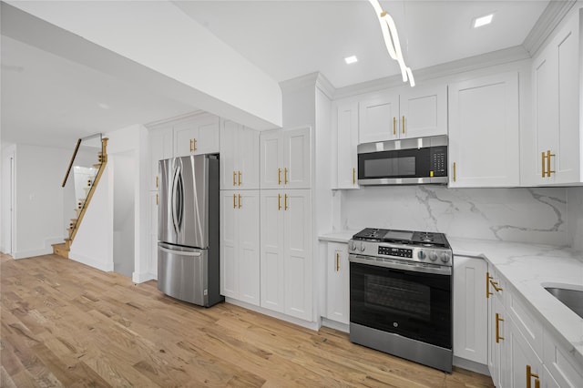 13015 Sutter Ave, South Ozone Park, NY 11420 - kitchen featuring stainless steel appliances, tasteful backsplash, light wood-style flooring, white cabinetry, and light stone countertops