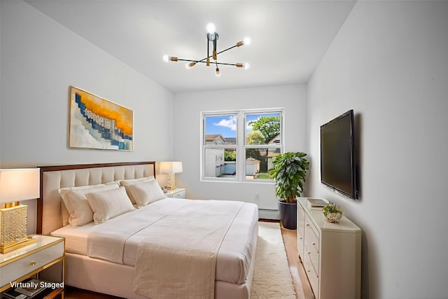 13015 Sutter Ave, South Ozone Park, NY 11420 - bedroom with a chandelier, baseboard heating, and light wood finished floors