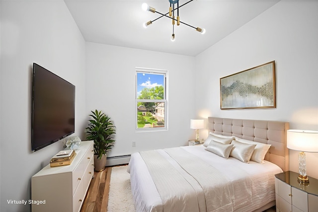 13015 Sutter Ave, South Ozone Park, NY 11420 - bedroom featuring a chandelier, wood finished floors, and baseboard heating