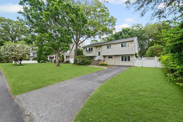 1291 Minerva Ave, West Islip, NY 11795 - bi-level home featuring asphalt driveway
