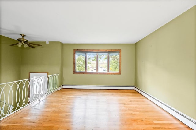 1291 Minerva Ave, West Islip, NY 11795 - spare room with a baseboard heating unit, a baseboard radiator, wood finished floors, and a ceiling fan