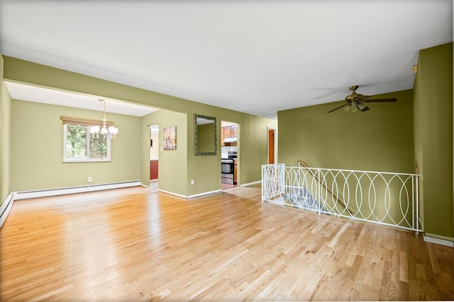 1291 Minerva Ave, West Islip, NY 11795 - spare room with baseboard heating, wood finished floors, a chandelier, and a ceiling fan