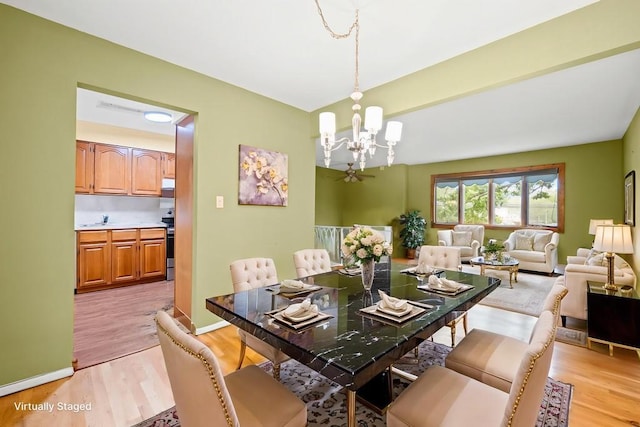 1291 Minerva Ave, West Islip, NY 11795 - dining room with a chandelier and light wood-style flooring