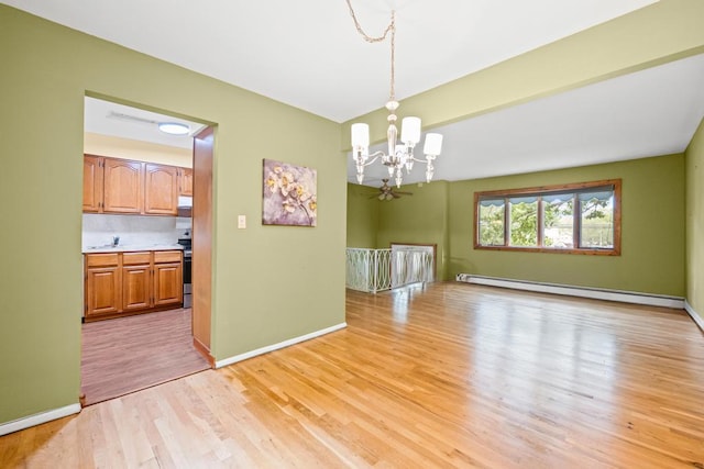 1291 Minerva Ave, West Islip, NY 11795 - empty room featuring a baseboard radiator, a chandelier, and light wood-style flooring