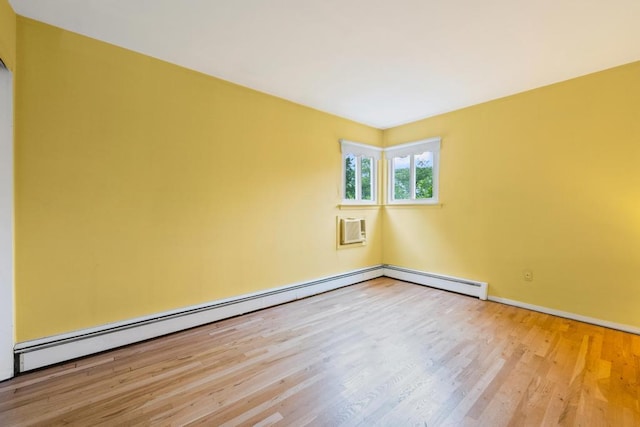 1291 Minerva Ave, West Islip, NY 11795 - empty room featuring wood finished floors, baseboard heating, and a wall mounted air conditioner