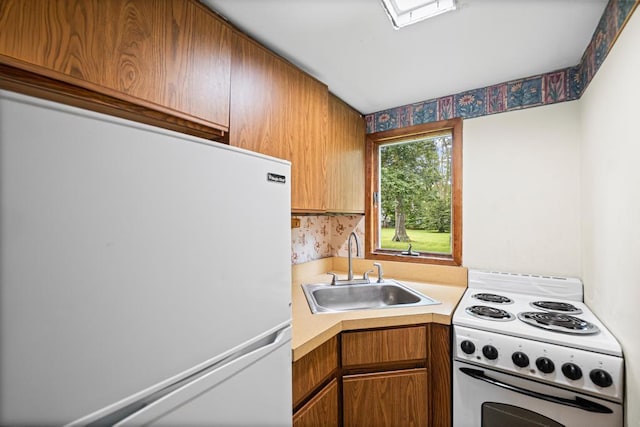 1291 Minerva Ave, West Islip, NY 11795 - kitchen with white appliances, light countertops, and brown cabinets