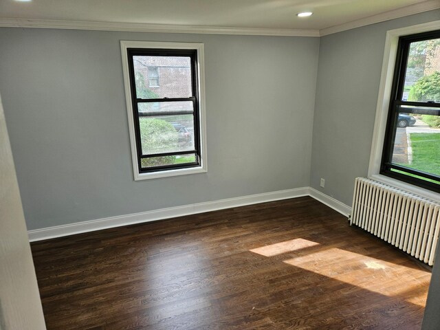 300 Richbell Rd Unit B2, Mamaroneck, NY 10543 - spare room featuring radiator, dark wood-style flooring, ornamental molding, and recessed lighting