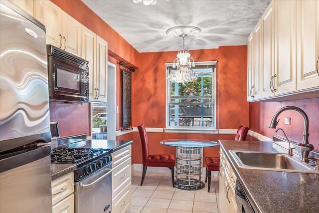 162-01 Powells Cove Blvd Unit 1J, Beechhurst, NY 11357 - kitchen with stainless steel appliances, a chandelier, light tile patterned floors, and hanging light fixtures