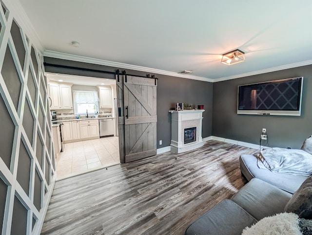 14 Hampton Rd, Sound Beach, NY 11789 - living area featuring crown molding, a barn door, light wood-type flooring, and a glass covered fireplace