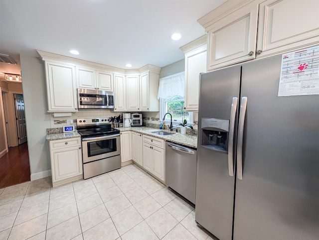 14 Hampton Rd, Sound Beach, NY 11789 - kitchen featuring appliances with stainless steel finishes, light stone countertops, backsplash, light tile patterned floors, and recessed lighting